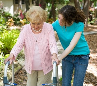 elder caregiver helping grandmother